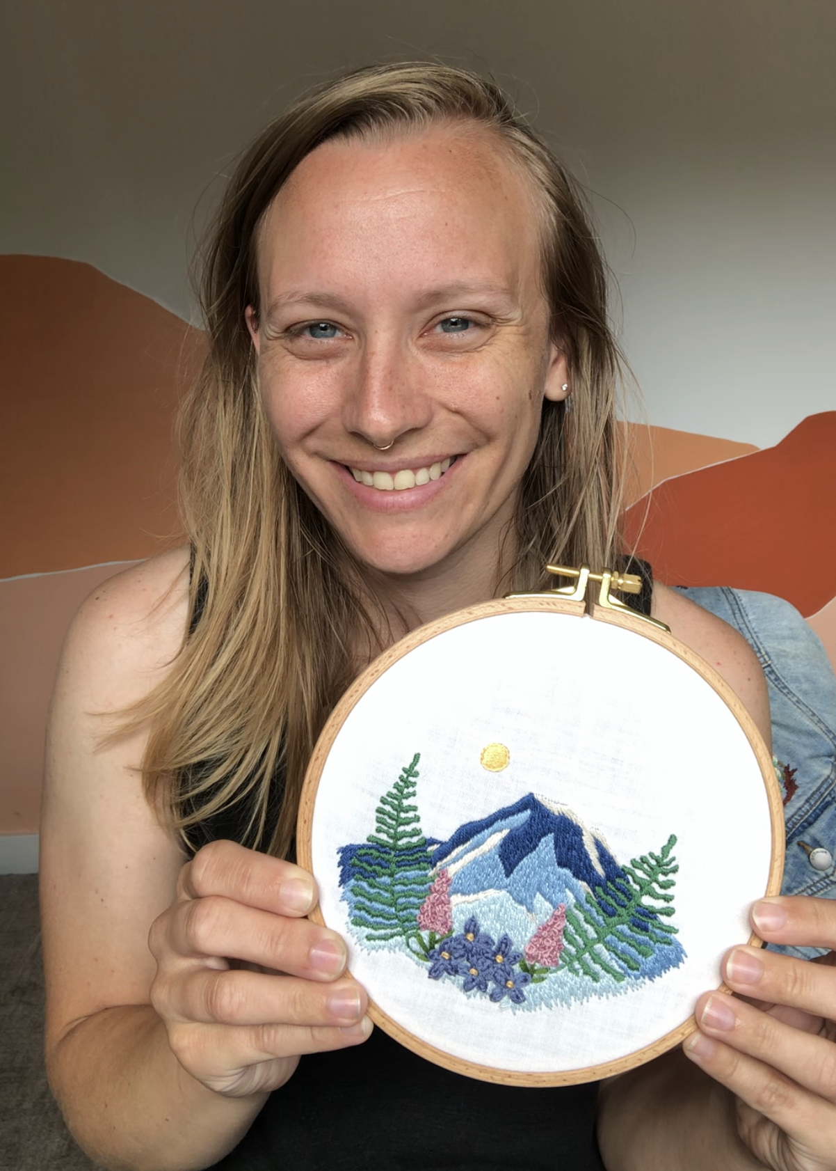 Melissa from MCreativeJ holding a completed embroidery design.