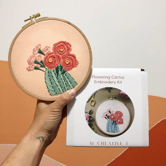 Finished design for flower cactus embroidery kit. Displayed next to kit box