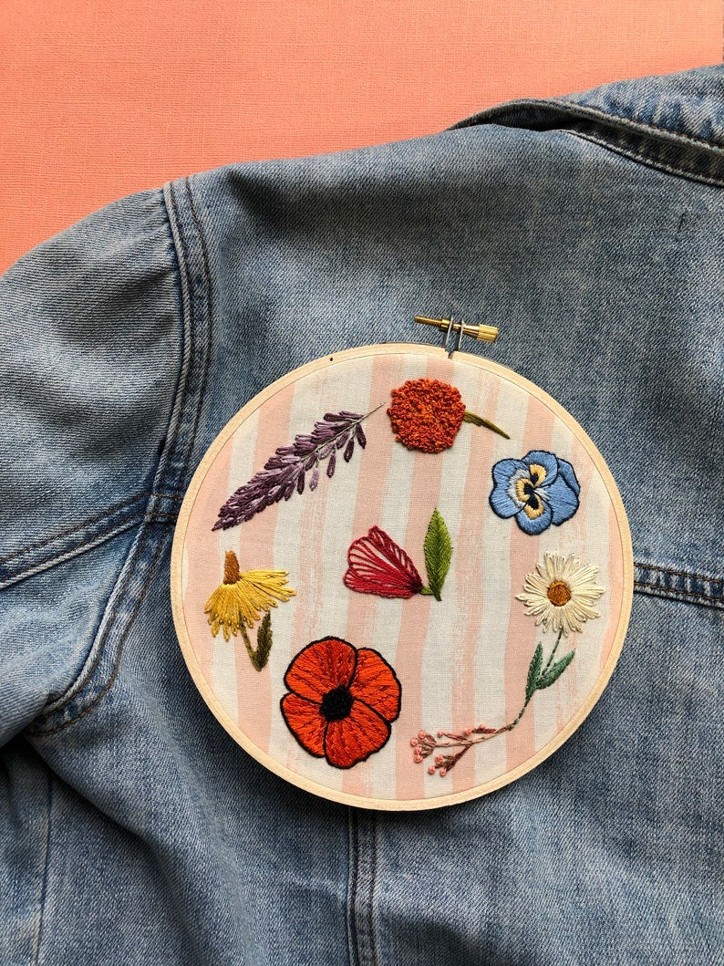 Completed Design of Wildflower Stick and Stitch Embroidery Pattern Kit in Hoop Against Jean Jacket
